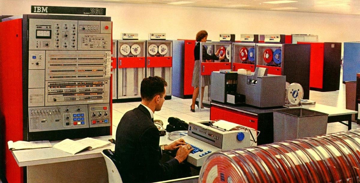 People working on an IBM mainframe computer.